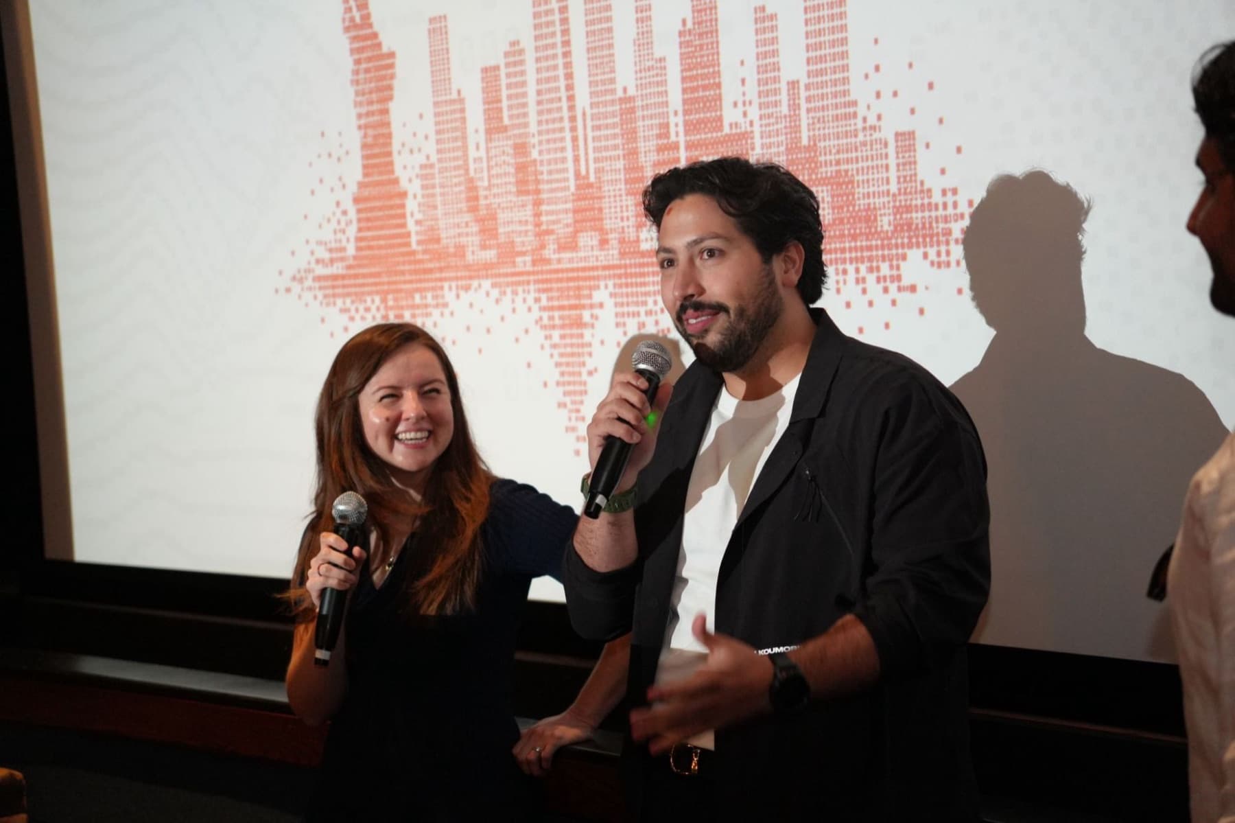 Pygma hosts on stage at a community event in New York